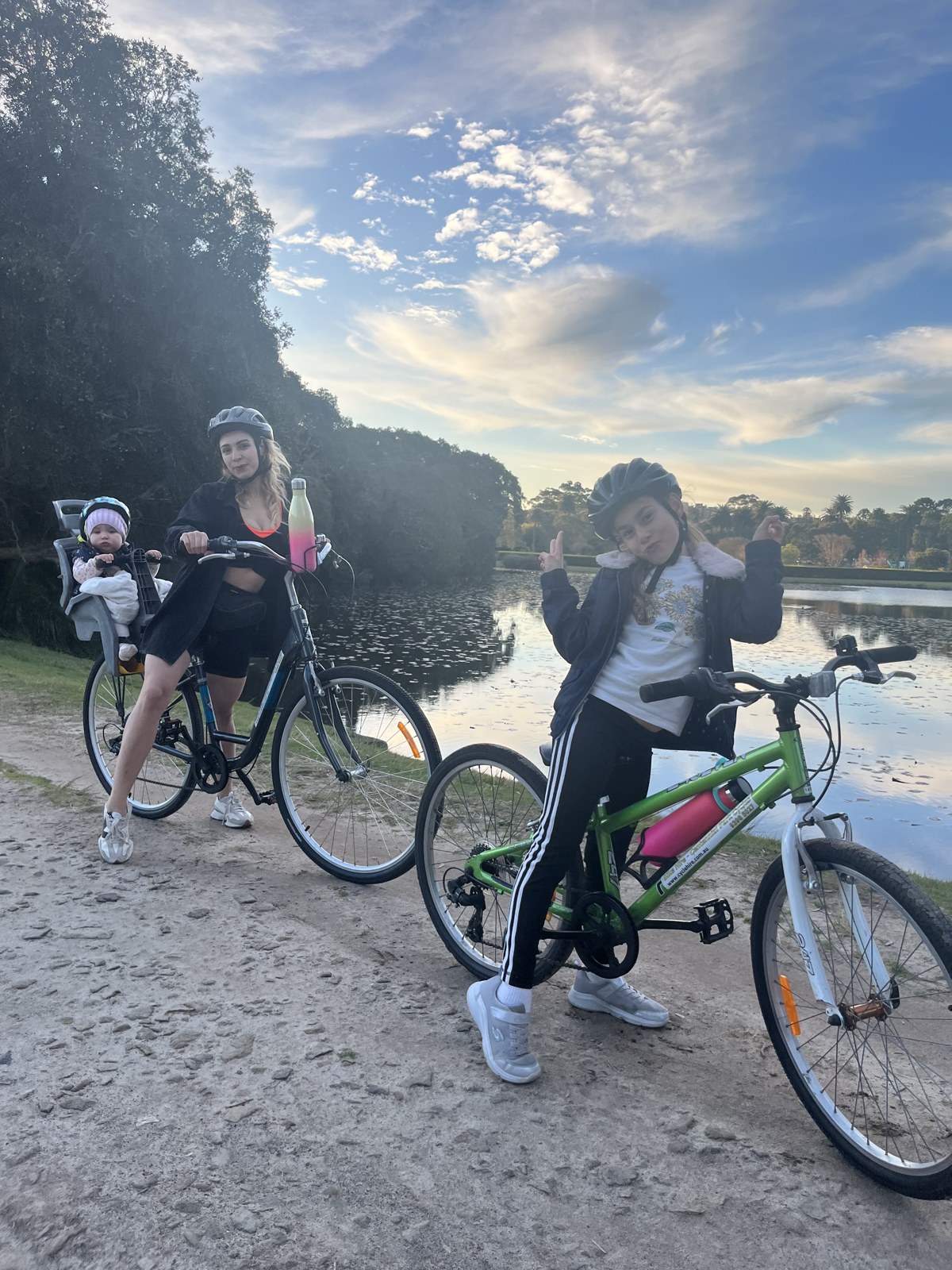 Maria on a family bike ride with her two daughters beside a lake
